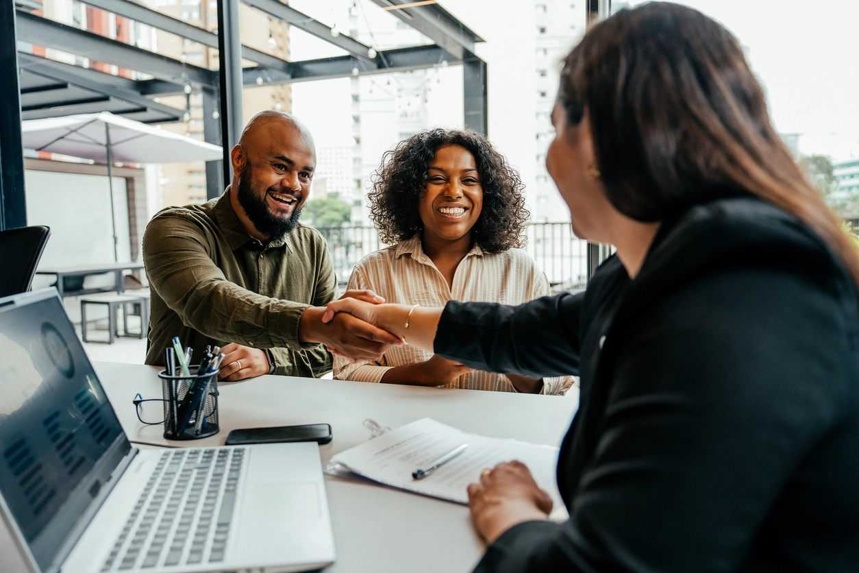 A couple meeting with a real estate agent.